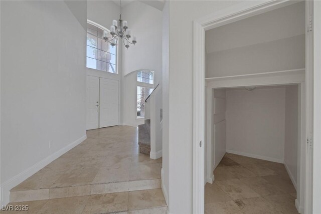 829 Dancing Vines Ave, Las Vegas, NV 89183 - entryway featuring a chandelier, stairs, baseboards, and a towering ceiling