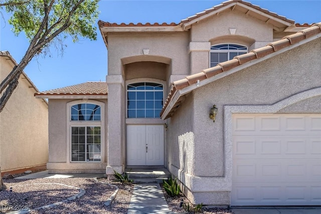 829 Dancing Vines Ave, Las Vegas, NV 89183 - entrance to property featuring a tile roof, an attached garage, and stucco siding