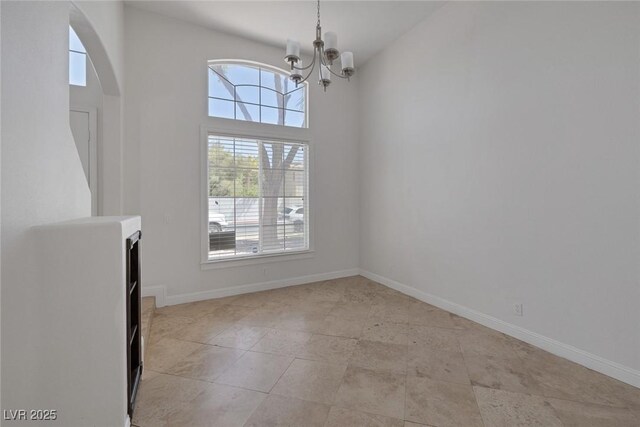 829 Dancing Vines Ave, Las Vegas, NV 89183 - unfurnished dining area with plenty of natural light, a chandelier, arched walkways, and baseboards