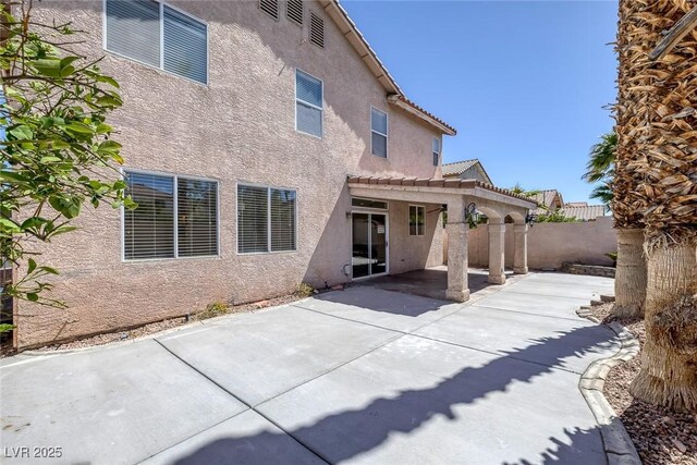 829 Dancing Vines Ave, Las Vegas, NV 89183 - back of house with stucco siding, a fenced backyard, a patio area, and a tiled roof