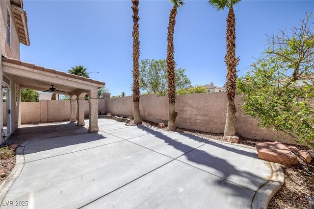 829 Dancing Vines Ave, Las Vegas, NV 89183 - fenced backyard featuring a ceiling fan and a patio area