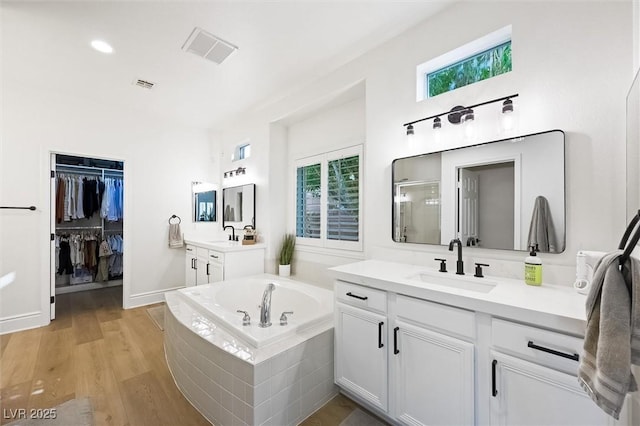 11340 Espadrille Ct, Las Vegas, NV 89138 - full bathroom with two vanities, a garden tub, a shower stall, and plenty of natural light