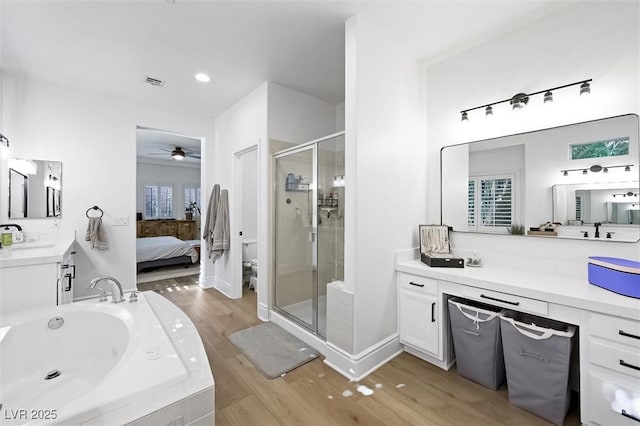 11340 Espadrille Ct, Las Vegas, NV 89138 - full bathroom featuring a shower stall, a jetted tub, ceiling fan, wood finished floors, and vanity