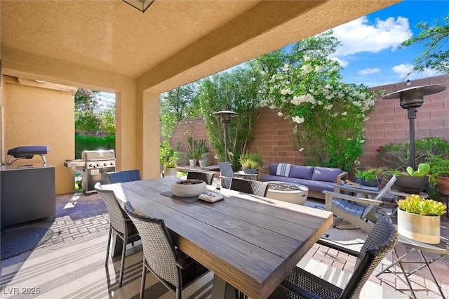 11340 Espadrille Ct, Las Vegas, NV 89138 - fenced backyard with grilling area, a patio, outdoor dining area, and an outdoor hangout area