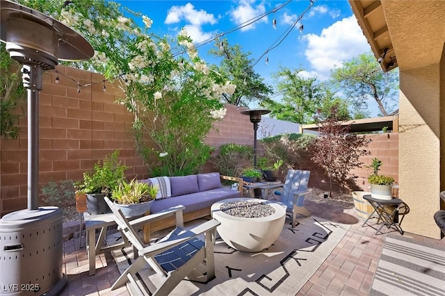 11340 Espadrille Ct, Las Vegas, NV 89138 - fenced backyard featuring a patio and an outdoor living space with a fire pit