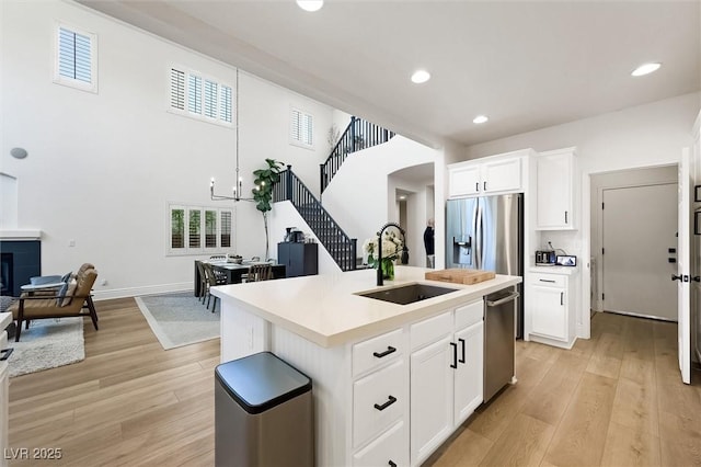 11340 Espadrille Ct, Las Vegas, NV 89138 - kitchen with a sink, appliances with stainless steel finishes, light wood-style flooring, light countertops, and recessed lighting
