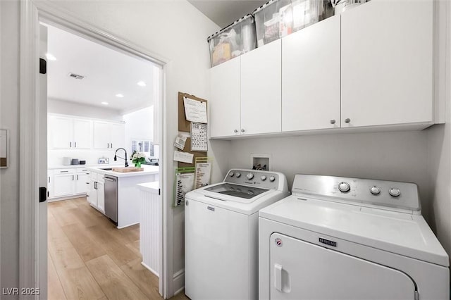 11340 Espadrille Ct, Las Vegas, NV 89138 - laundry area with independent washer and dryer, light wood-style floors, cabinet space, and recessed lighting