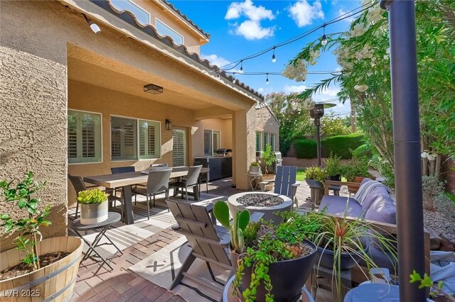 11340 Espadrille Ct, Las Vegas, NV 89138 - view of patio with a fire pit and outdoor dining space