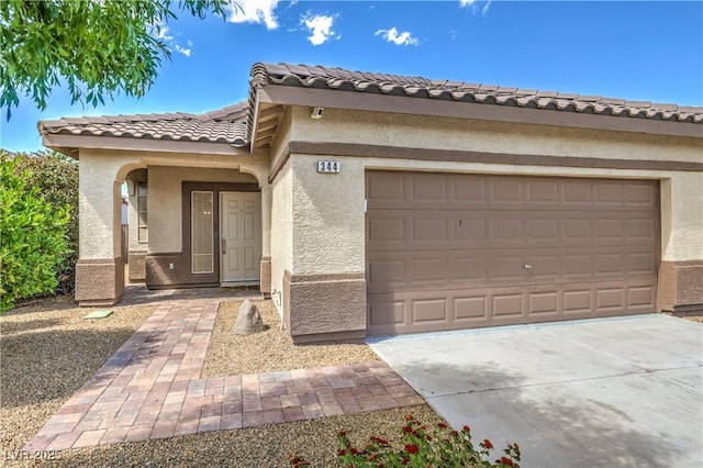 344 Golden Shore Dr, Las Vegas, NV 89123 - view of front of house featuring a tile roof, stucco siding, a garage, and driveway