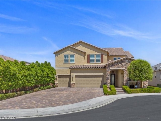 2400 Trissino Ct, Henderson, NV 89044 - view of front of house featuring stone siding, stucco siding, decorative driveway, and an attached garage