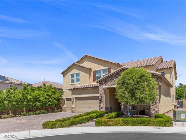 2400 Trissino Ct, Henderson, NV 89044 - view of front of property featuring stone siding, driveway, stucco siding, and a tile roof