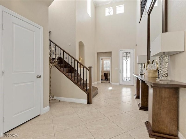 2400 Trissino Ct, Henderson, NV 89044 - foyer featuring stairs, plenty of natural light, baseboards, light tile patterned floors, and a high ceiling
