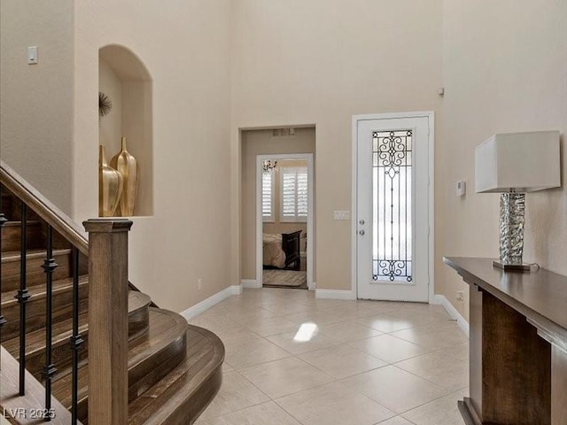 2400 Trissino Ct, Henderson, NV 89044 - foyer entrance with a high ceiling, baseboards, stairs, and light tile patterned floors