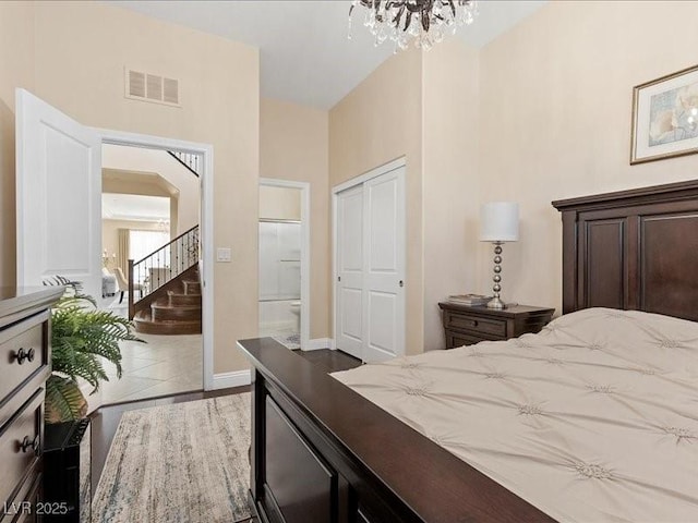 2400 Trissino Ct, Henderson, NV 89044 - tiled bedroom featuring a chandelier, a closet, baseboards, and connected bathroom