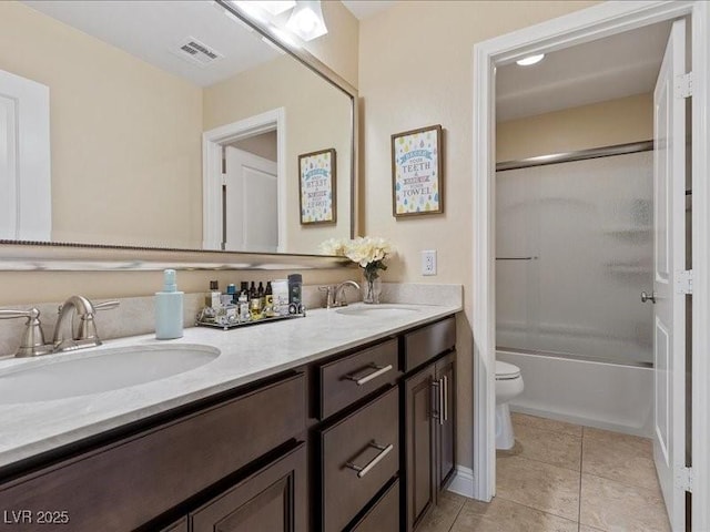 2400 Trissino Ct, Henderson, NV 89044 - full bath with toilet, double vanity, shower / bath combination with glass door, and tile patterned flooring