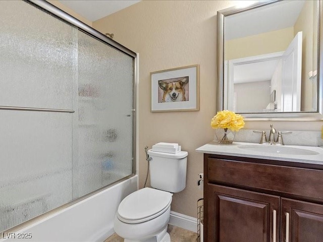 2400 Trissino Ct, Henderson, NV 89044 - bathroom featuring vanity, toilet, combined bath / shower with glass door, and baseboards