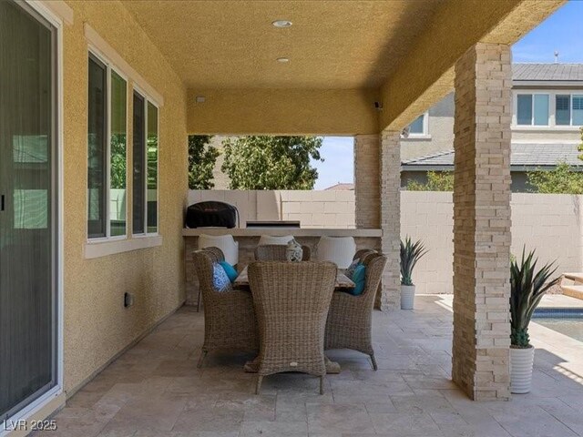 2400 Trissino Ct, Henderson, NV 89044 - view of patio / terrace featuring exterior kitchen and outdoor dining space
