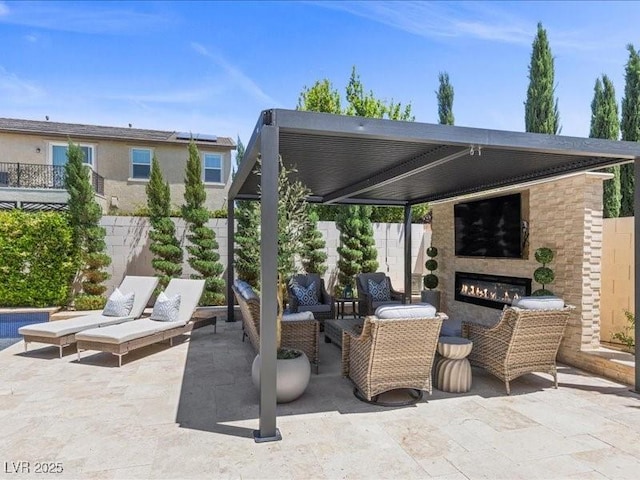 2400 Trissino Ct, Henderson, NV 89044 - view of patio with an outdoor living space with a fireplace