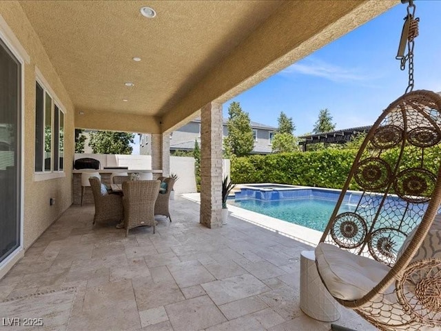 2400 Trissino Ct, Henderson, NV 89044 - fenced backyard with a patio area, an in-ground hot tub, and an outdoor kitchen