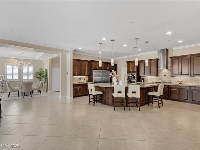 2400 Trissino Ct, Henderson, NV 89044 - kitchen with stainless steel built in fridge, wall chimney exhaust hood, tasteful backsplash, a breakfast bar, and ornamental molding