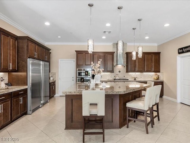 2400 Trissino Ct, Henderson, NV 89044 - kitchen featuring appliances with stainless steel finishes, wall chimney range hood, tasteful backsplash, a spacious island, and light tile patterned flooring