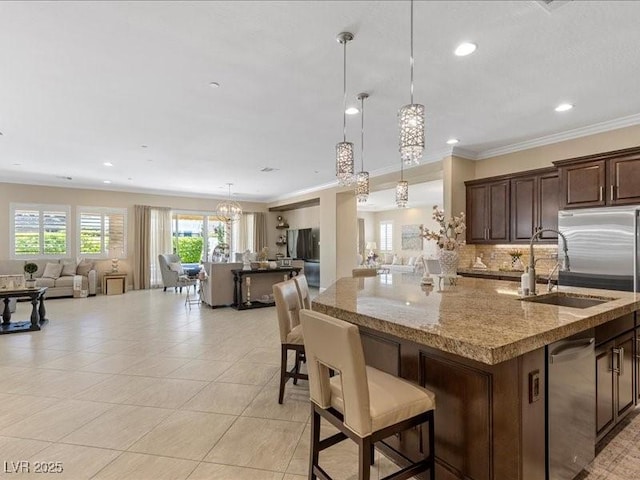2400 Trissino Ct, Henderson, NV 89044 - kitchen with open floor plan, a kitchen island with sink, a sink, tasteful backsplash, and stainless steel appliances
