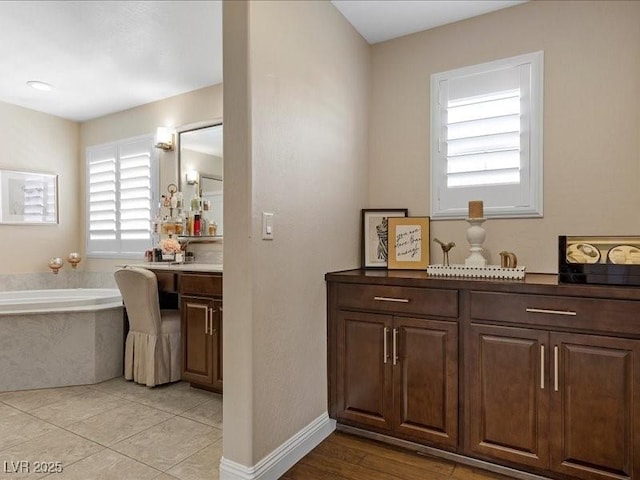 2400 Trissino Ct, Henderson, NV 89044 - bathroom featuring vanity, a garden tub, and baseboards