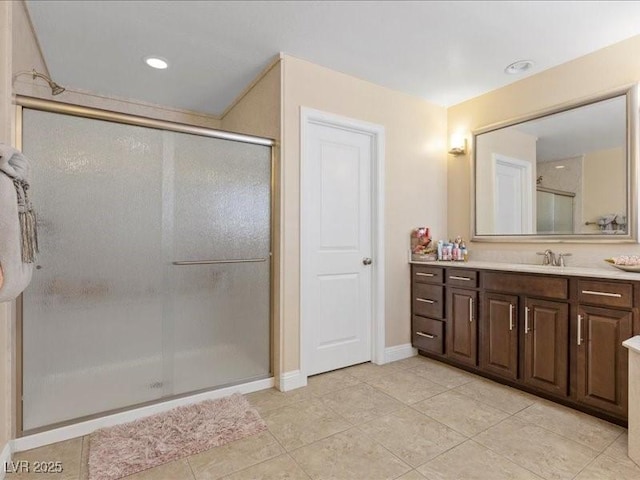 2400 Trissino Ct, Henderson, NV 89044 - bathroom featuring vanity, a shower stall, tile patterned flooring, and baseboards