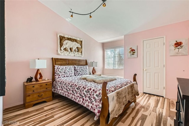 2725 S Nellis Blvd Unit 2084, Las Vegas, NV 89121 - bedroom with light wood finished floors and lofted ceiling