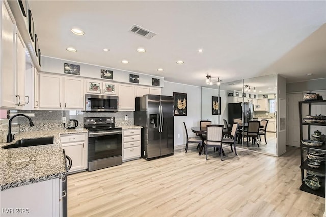2725 S Nellis Blvd Unit 2084, Las Vegas, NV 89121 - kitchen featuring a sink, appliances with stainless steel finishes, tasteful backsplash, light stone countertops, and recessed lighting