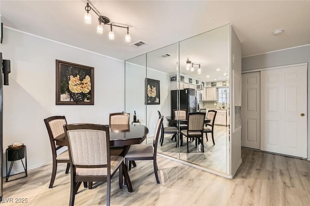 2725 S Nellis Blvd Unit 2084, Las Vegas, NV 89121 - dining room with light wood-type flooring and track lighting