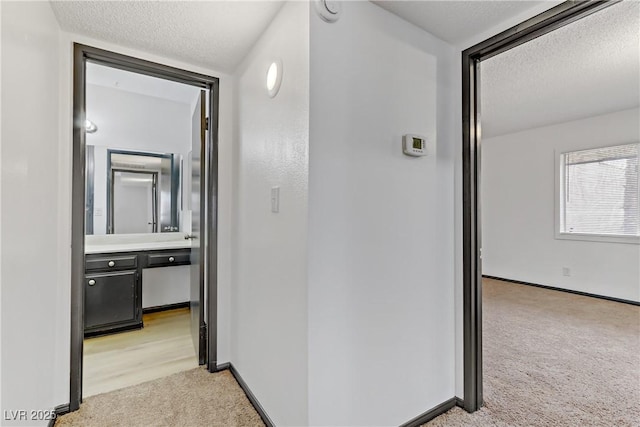 1390 Vegas Valley Dr Unit 26, Las Vegas, NV 89169 - corridor featuring light carpet, a textured ceiling, and baseboards
