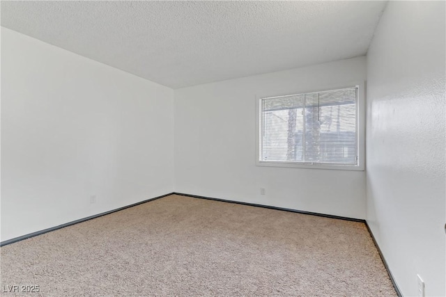 1390 Vegas Valley Dr Unit 26, Las Vegas, NV 89169 - carpeted spare room with a textured ceiling and baseboards