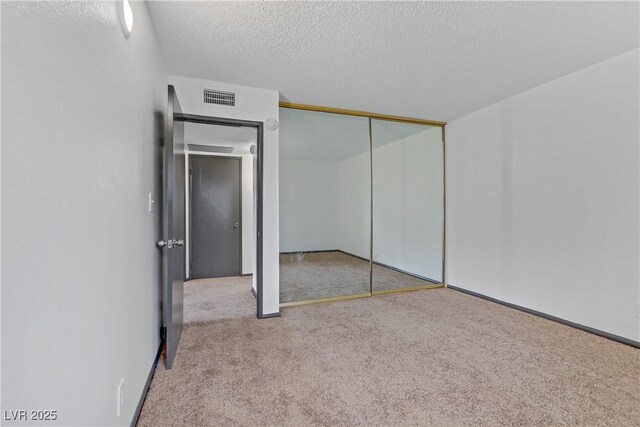 1390 Vegas Valley Dr Unit 26, Las Vegas, NV 89169 - unfurnished bedroom with carpet, a textured ceiling, and a closet