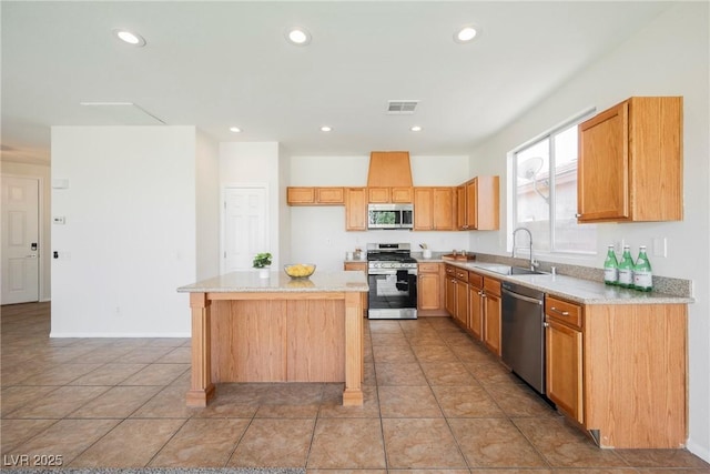 909 Trinity Pond Cir, Henderson, NV 89002 - kitchen featuring appliances with stainless steel finishes, a sink, a kitchen island, light countertops, and recessed lighting