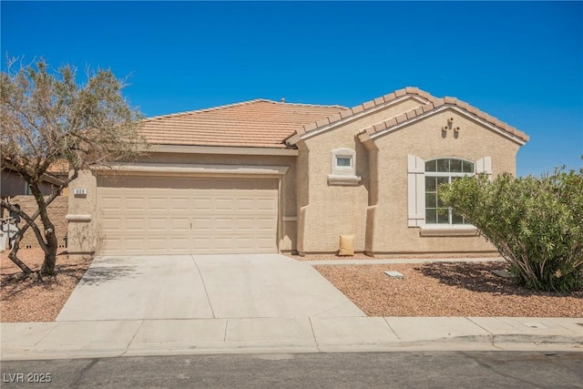 909 Trinity Pond Cir, Henderson, NV 89002 - view of front facade with a garage, stucco siding, driveway, and a tiled roof
