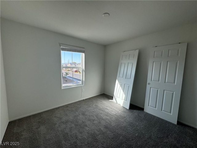 5175 Capucina St Lot 5, Las Vegas, NV 89122 - unfurnished bedroom featuring dark carpet and baseboards