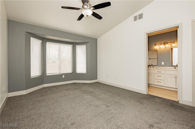 10309 Georgetown Pl, Las Vegas, NV 89134 - empty room with vaulted ceiling, light colored carpet, ceiling fan, baseboards, and a sink