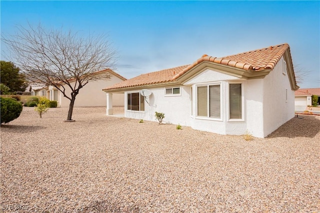 10309 Georgetown Pl, Las Vegas, NV 89134 - rear view of property featuring a tile roof and stucco siding