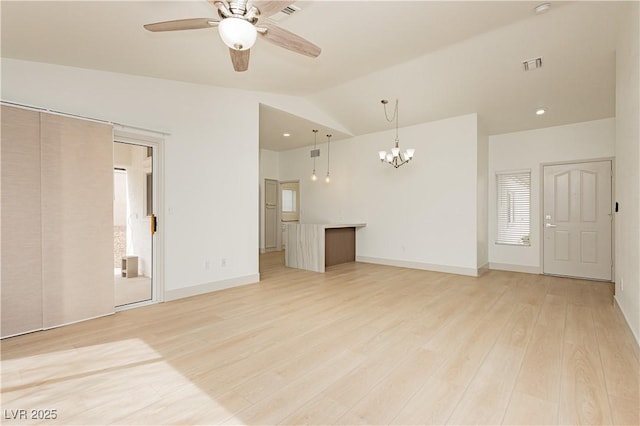 10309 Georgetown Pl, Las Vegas, NV 89134 - unfurnished living room with ceiling fan, a chandelier, lofted ceiling, plenty of natural light, and light wood-style flooring