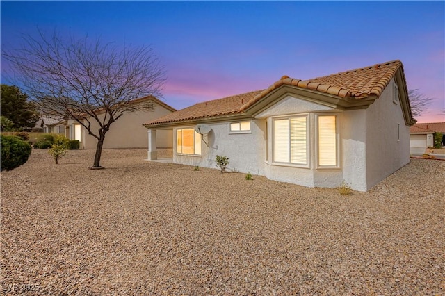 10309 Georgetown Pl, Las Vegas, NV 89134 - back of house at dusk featuring a tile roof and stucco siding