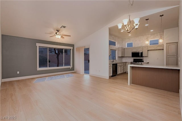 10309 Georgetown Pl, Las Vegas, NV 89134 - kitchen featuring appliances with stainless steel finishes, open floor plan, light countertops, a chandelier, and high vaulted ceiling