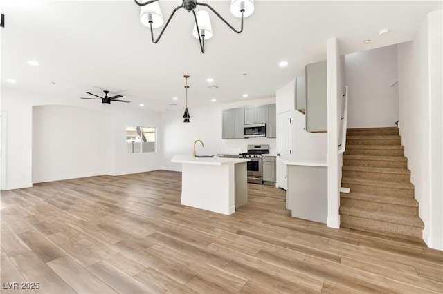 4779 Straight Flush Dr Unit 103, Las Vegas, NV 89122 - kitchen featuring stainless steel appliances, gray cabinetry, light countertops, open floor plan, and a sink