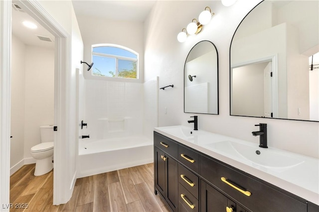 4779 Straight Flush Dr Unit 103, Las Vegas, NV 89122 - full bathroom with double vanity, toilet, wood finished floors, and shower / bath combination