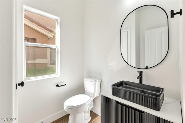 4779 Straight Flush Dr Unit 103, Las Vegas, NV 89122 - bathroom with toilet, baseboards, wood finished floors, and vanity