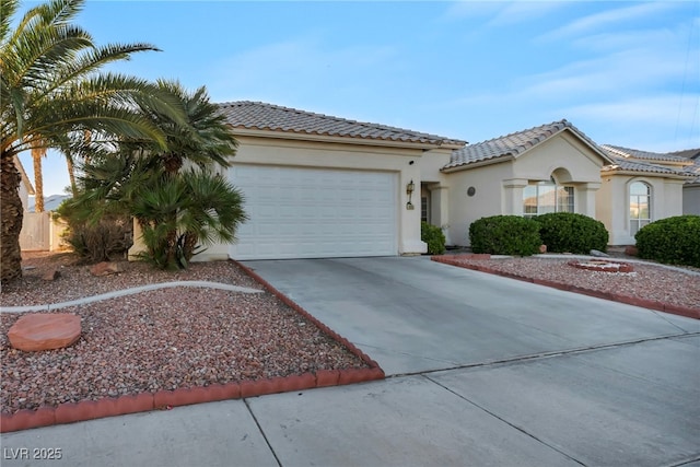 4005 Poppy Fields Dr, Las Vegas, NV 89129 - mediterranean / spanish home with a garage, concrete driveway, a tiled roof, and stucco siding