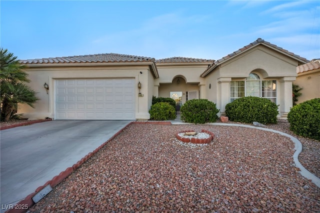 4005 Poppy Fields Dr, Las Vegas, NV 89129 - mediterranean / spanish house featuring driveway, stucco siding, a tile roof, and a garage