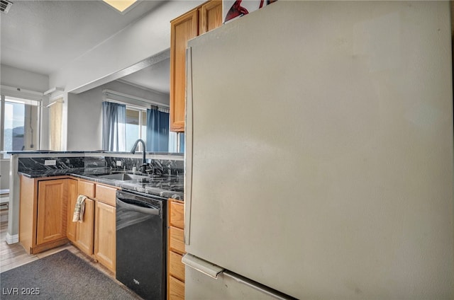4005 Poppy Fields Dr, Las Vegas, NV 89129 - kitchen with freestanding refrigerator, dishwasher, a sink, and a peninsula