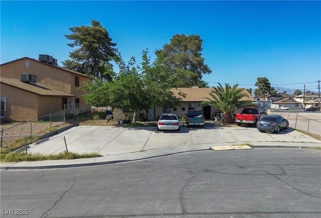 4 Britz Cir, North Las Vegas, NV 89030 - view of property hidden behind natural elements featuring uncovered parking, a residential view, and central AC