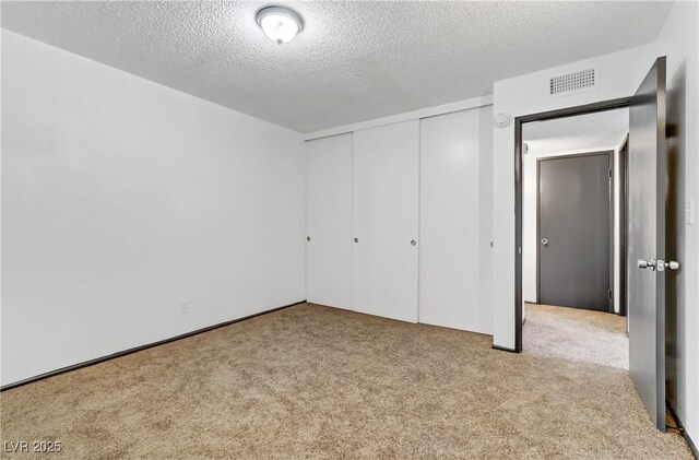 1390 Vegas Valley Dr Unit 32, Las Vegas, NV 89169 - unfurnished bedroom with carpet floors, a textured ceiling, and a closet